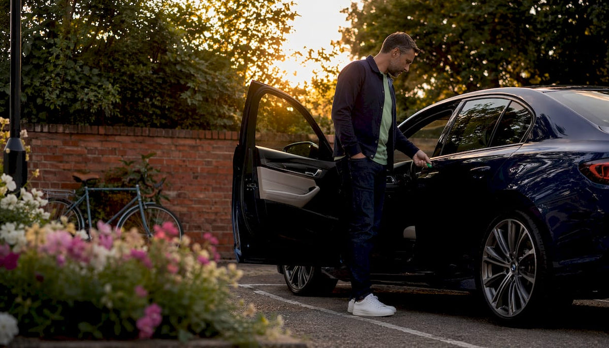 Man using car tracker driver identity tag