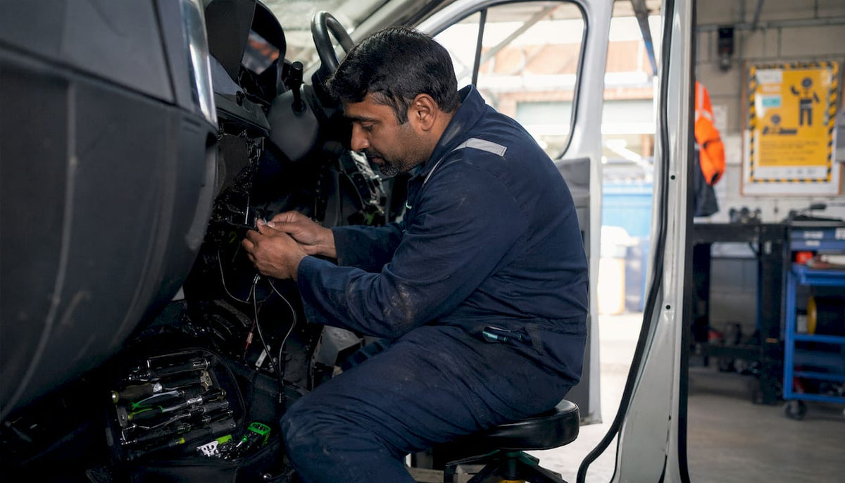 Tracker engineer installing device inside vehicle