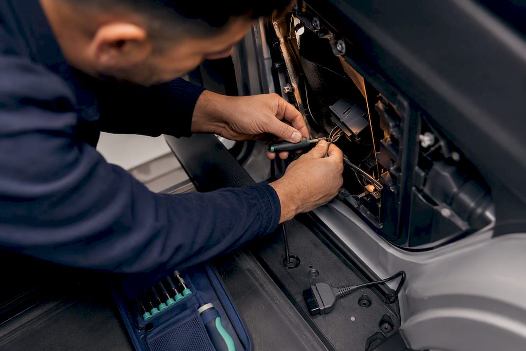 Installer securing concealed vehicle tracker wiring
