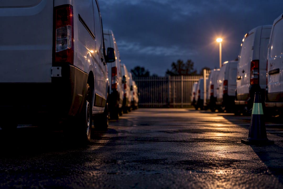 Cropped commercial vans in a secure recovery compound