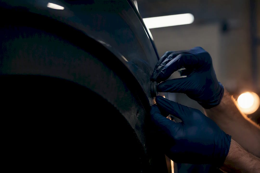 Fitter removing magnetic tracker from wheel arch